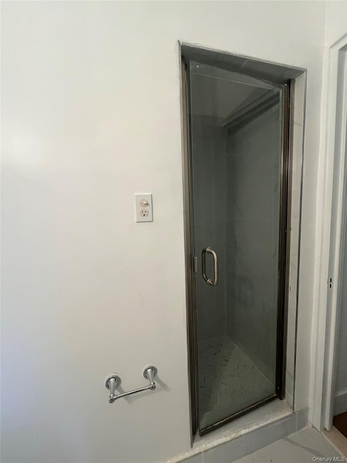 3810 Greystone Avenue, Unit 106 Bronx, NY 10463 - Photo 5 of 8 a bathroom with a glass shower door