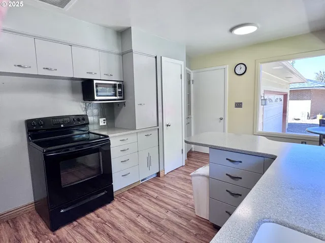 a kitchen with stainless steel appliances a stove a sink and a refrigerator