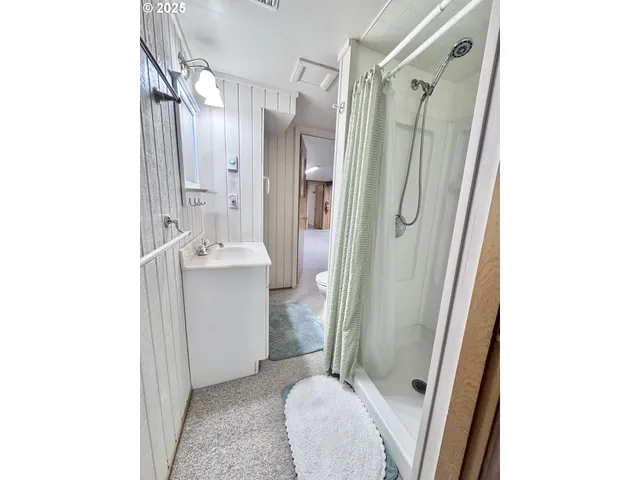 a bathroom with a shower and a sink