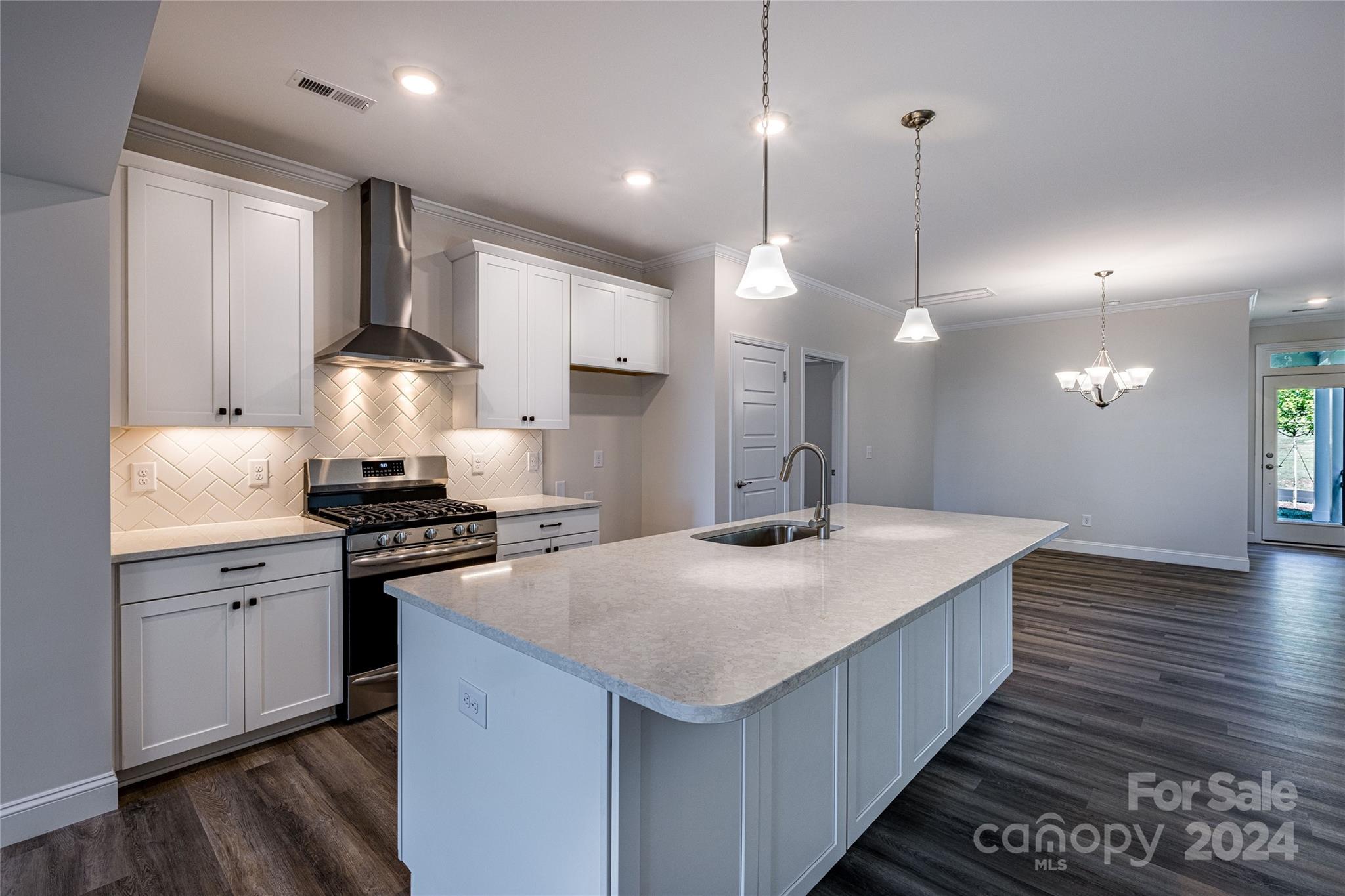 9531 Pointer Road, Unit 74 Huntersville, NC 28078 - Photo 6 of 16 a kitchen with stainless steel appliances granite countertop a sink a stove and a wooden floors
