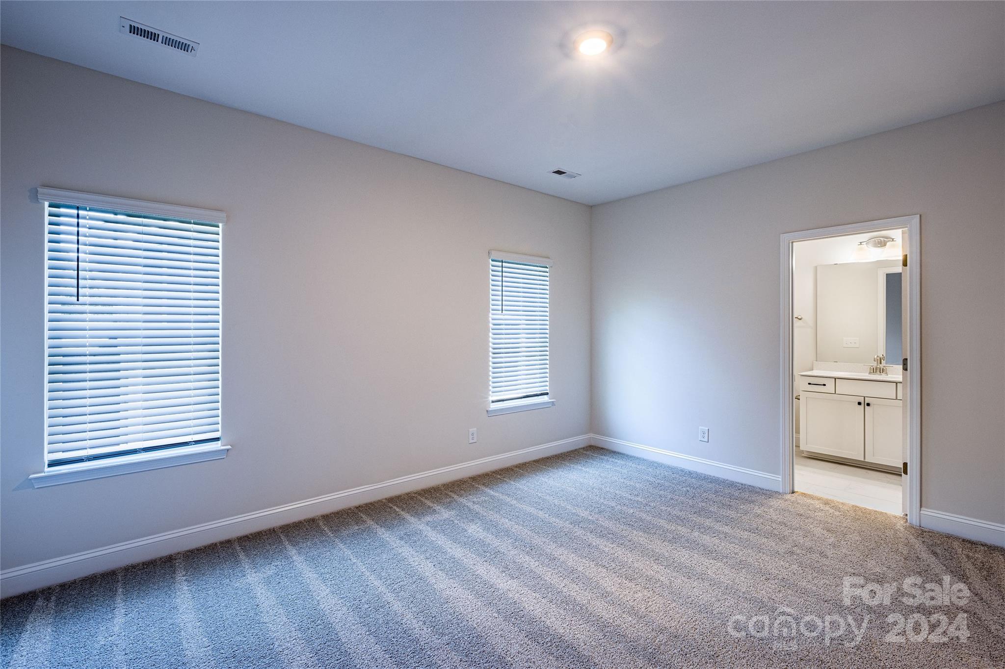 9531 Pointer Road, Unit 74 Huntersville, NC 28078 - Photo 10 of 16 a view of an empty room with wooden floor and a window