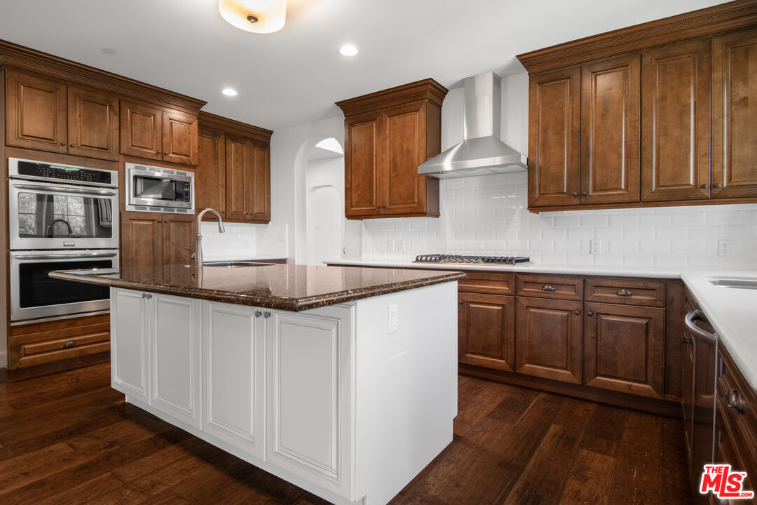 18326 Columbus Circle Tarzana, CA 91356 - Photo 11 of 34 a kitchen with stainless steel appliances granite countertop a stove a sink and a microwave