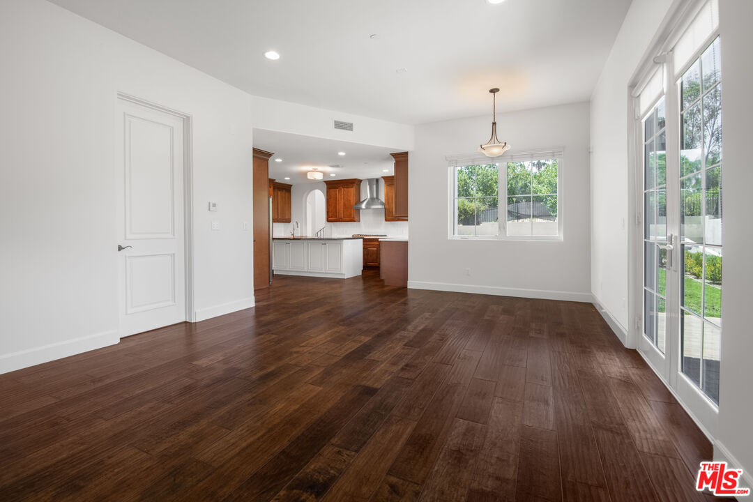 18326 Columbus Circle Tarzana, CA 91356 - Photo 12 of 34 an empty room with wooden floor and a window