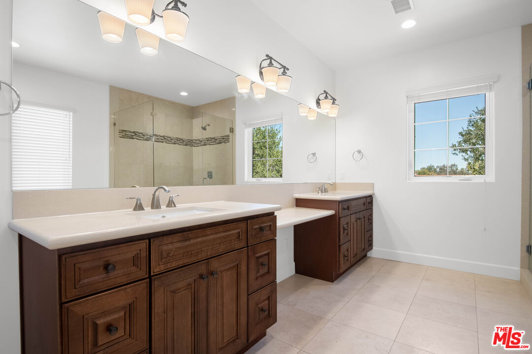 18326 Columbus Circle Tarzana, CA 91356 - Photo 19 of 34 a bathroom with a sink vanity and mirror