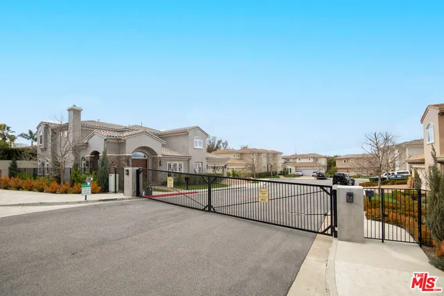 a front view of a house with plants