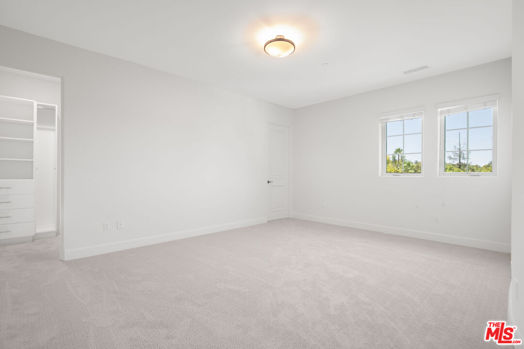 18326 Columbus Circle Tarzana, CA 91356 - Photo 23 of 34 an empty room with windows