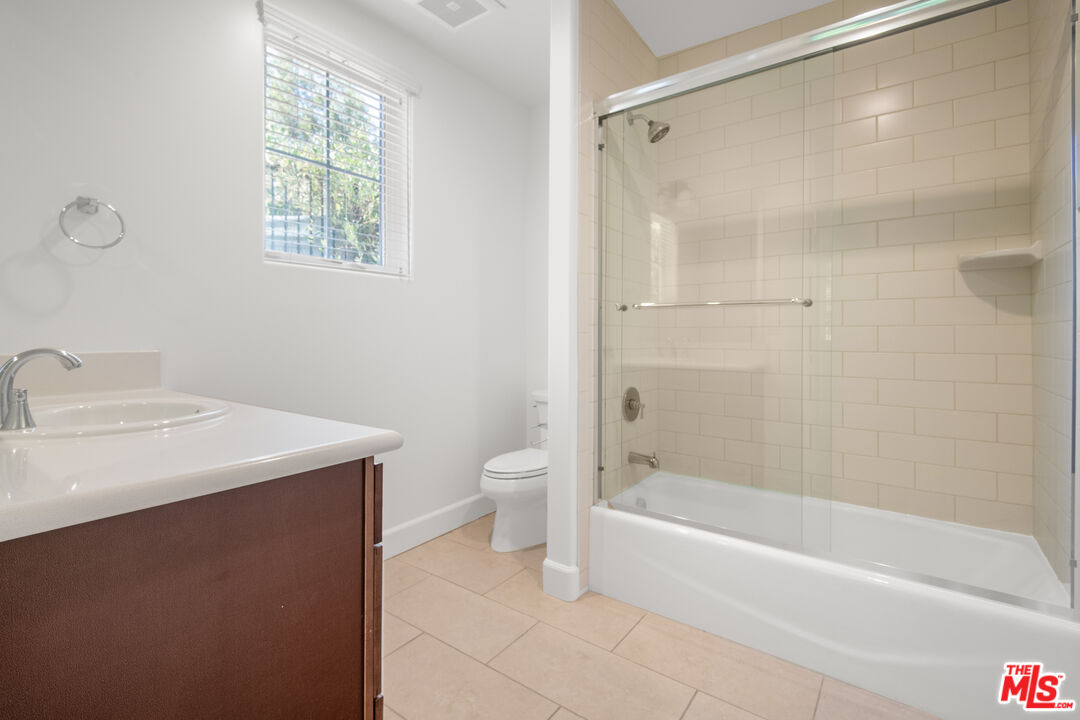 18326 Columbus Circle Tarzana, CA 91356 - Photo 24 of 34 a bathroom with a sink a toilet and shower