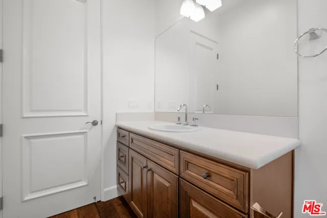 a bathroom with a sink a toilet a mirror and shower