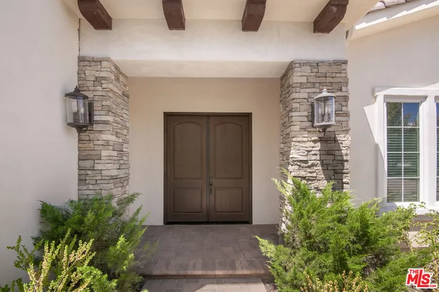 a view of entryway with wooden floor and stairs