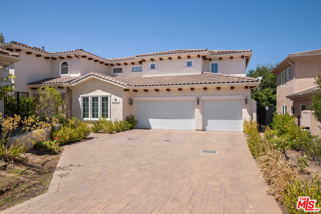 18326 Columbus Circle Tarzana, CA 91356 - Photo 32 of 34 a front view of a house with a garden