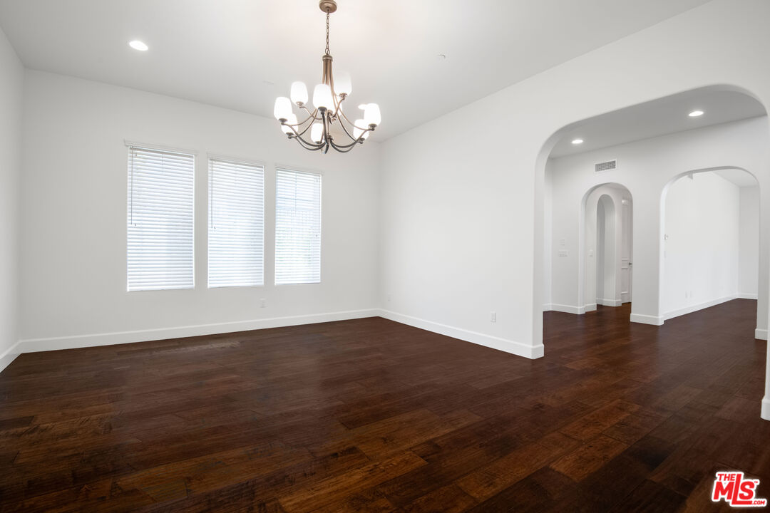 18326 Columbus Circle Tarzana, CA 91356 - Photo 9 of 34 a view of a livingroom with a chandelier fan and wooden floor