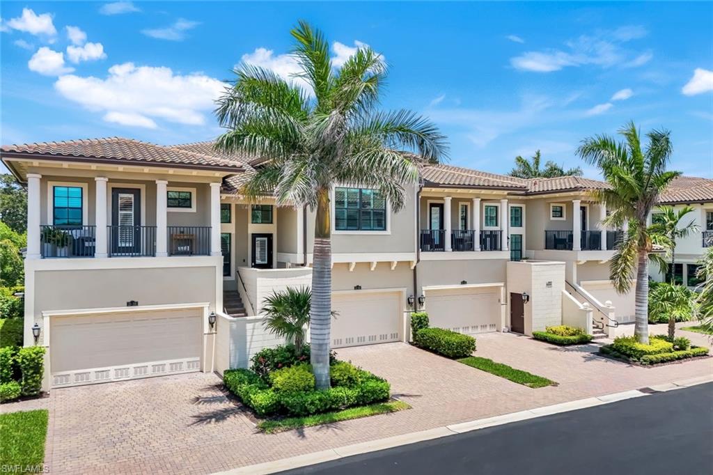 2488 Breakwater Way, Unit 201 Naples, FL 34112 - Photo 1 of 48 a front view of a house with a garden