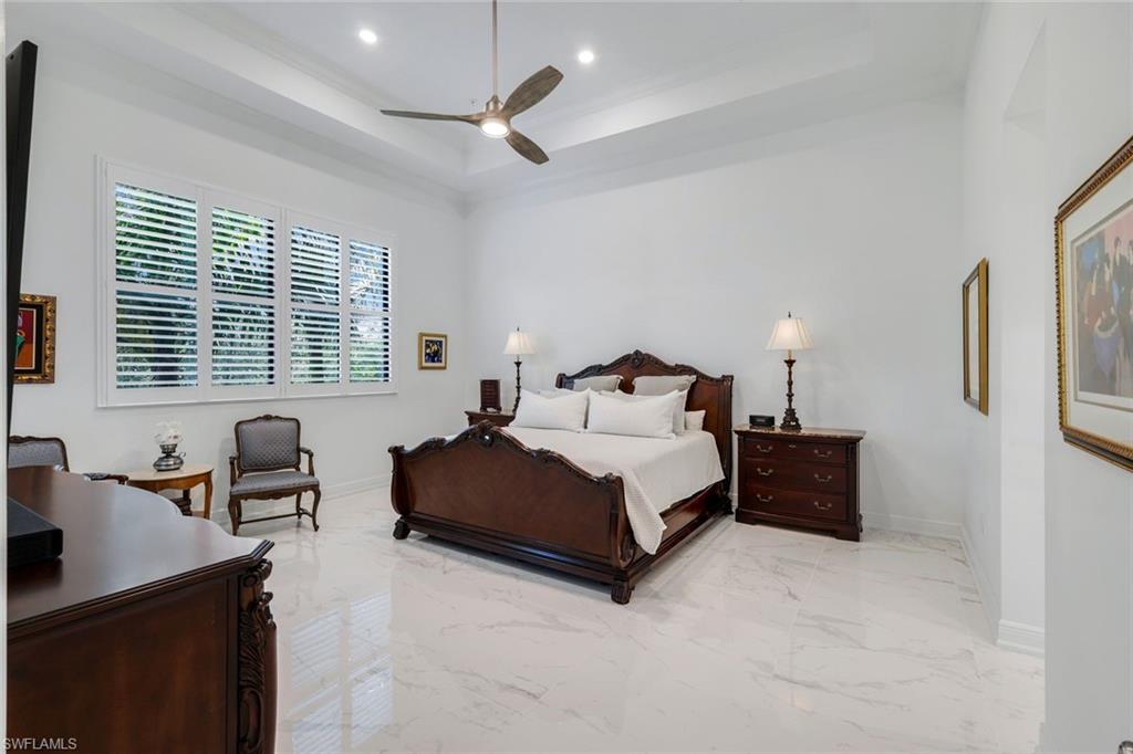 2488 Breakwater Way, Unit 201 Naples, FL 34112 - Photo 14 of 48 a bedroom with a bed chairs and with chair