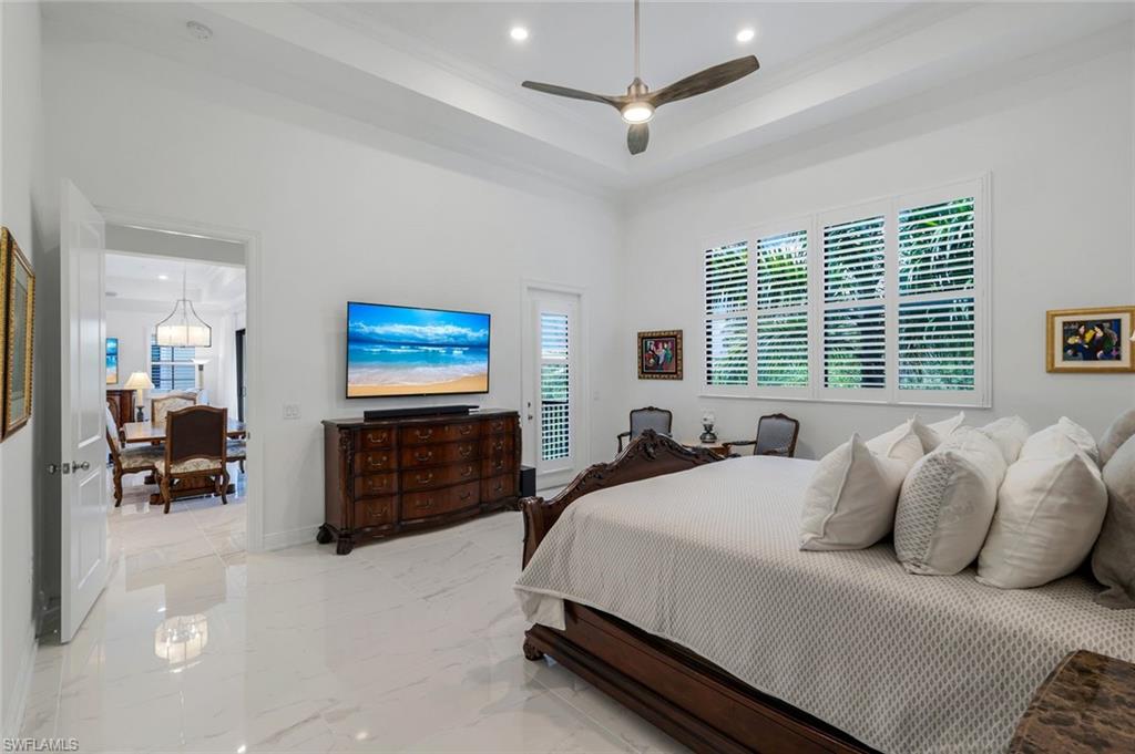 2488 Breakwater Way, Unit 201 Naples, FL 34112 - Photo 15 of 48 a bed room with a bed and a television