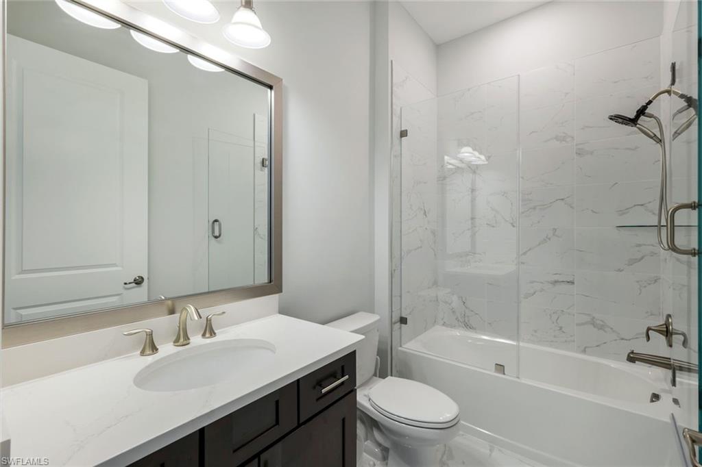 2488 Breakwater Way, Unit 201 Naples, FL 34112 - Photo 20 of 48 a bathroom with a sink toilet vanity and shower