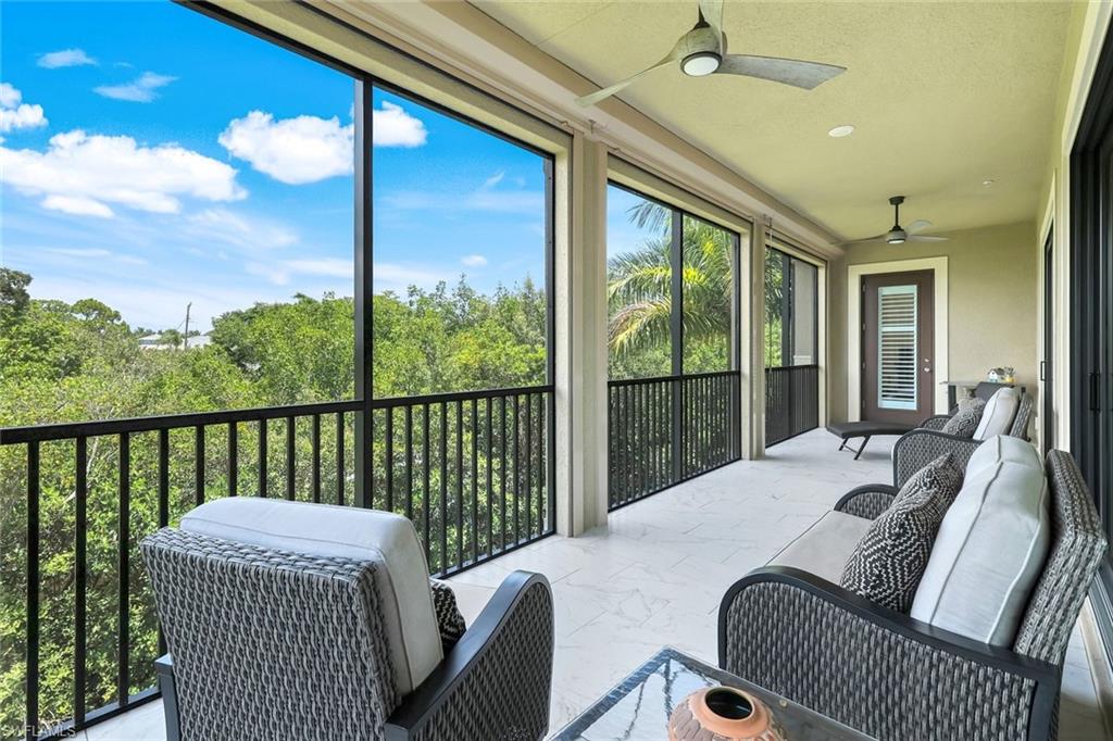 2488 Breakwater Way, Unit 201 Naples, FL 34112 - Photo 25 of 48 a balcony view with a couch