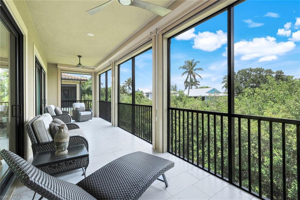 2488 Breakwater Way, Unit 201 Naples, FL 34112 - Photo 26 of 48 a living room with furniture and a large window