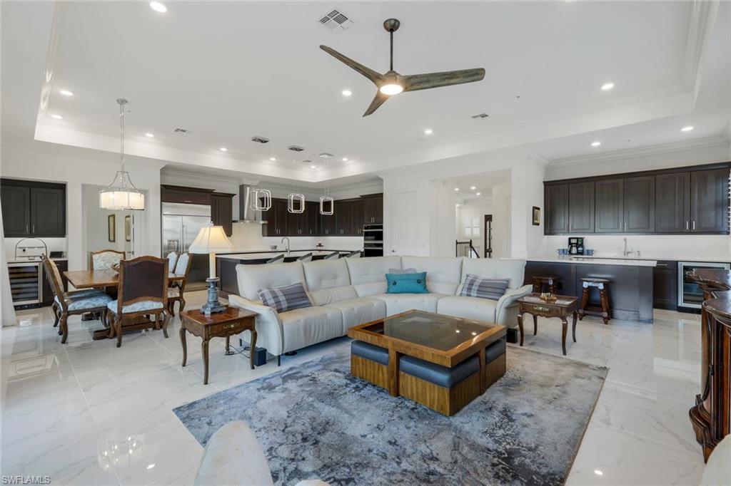 2488 Breakwater Way, Unit 201 Naples, FL 34112 - Photo 3 of 48 a living room with furniture kitchen view and a chandelier