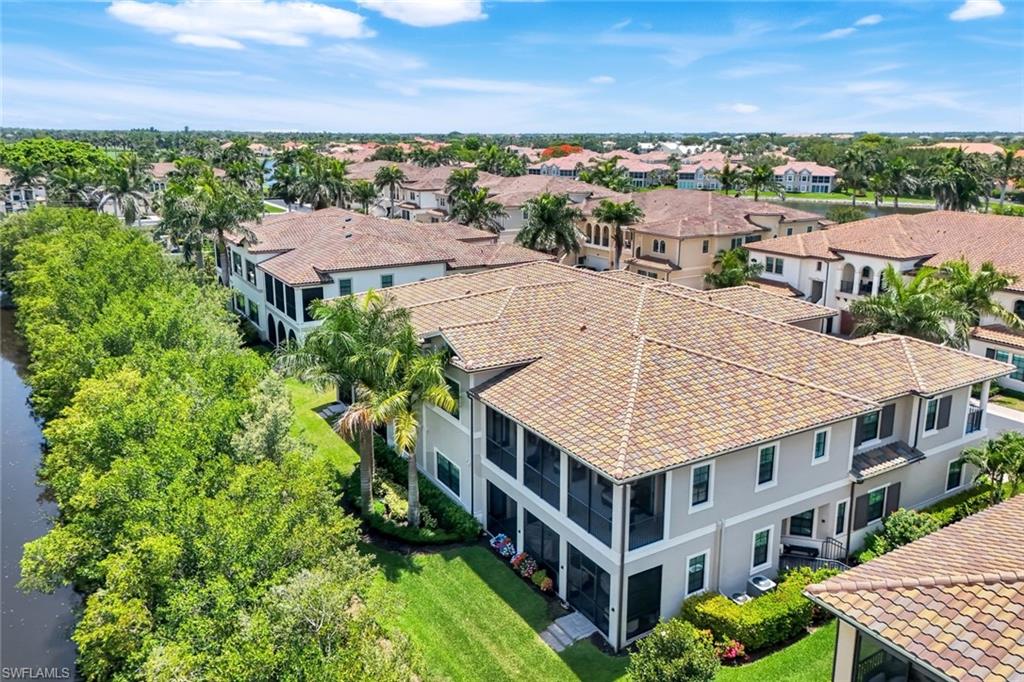 2488 Breakwater Way, Unit 201 Naples, FL 34112 - Photo 31 of 48 an aerial view of multiple houses with a yard