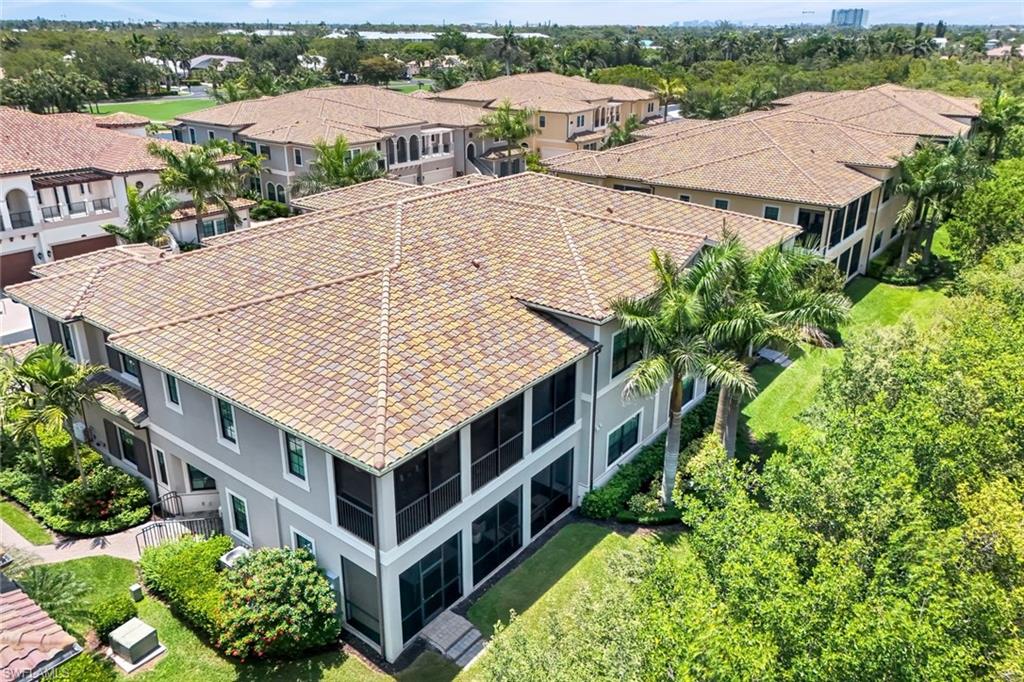 2488 Breakwater Way, Unit 201 Naples, FL 34112 - Photo 32 of 48 an aerial view of a house with a yard and large trees