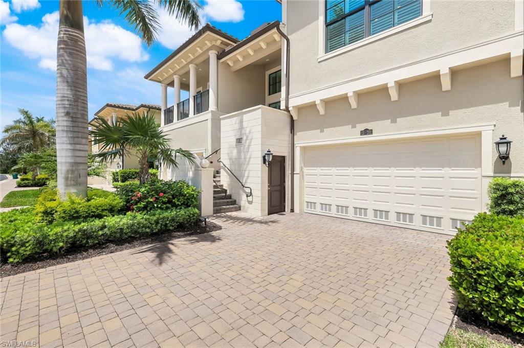 2488 Breakwater Way, Unit 201 Naples, FL 34112 - Photo 33 of 48 a view of a house with a yard and potted plants