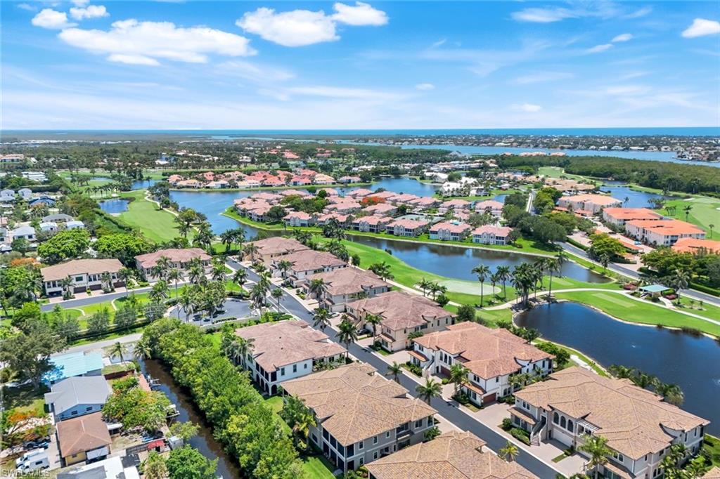 2488 Breakwater Way, Unit 201 Naples, FL 34112 - Photo 36 of 48 an aerial view of a city with lots of residential buildings ocean and mountain view in back
