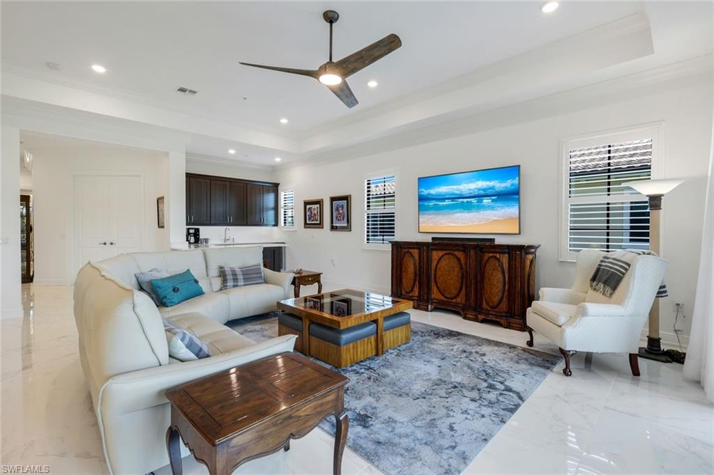 2488 Breakwater Way, Unit 201 Naples, FL 34112 - Photo 6 of 48 a living room with furniture a rug and a flat screen tv