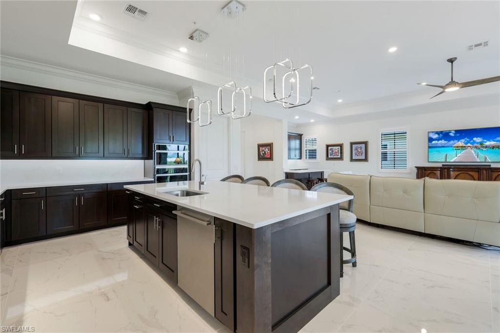 2488 Breakwater Way, Unit 201 Naples, FL 34112 - Photo 8 of 48 a kitchen with a sink and a stove top oven with wooden floor