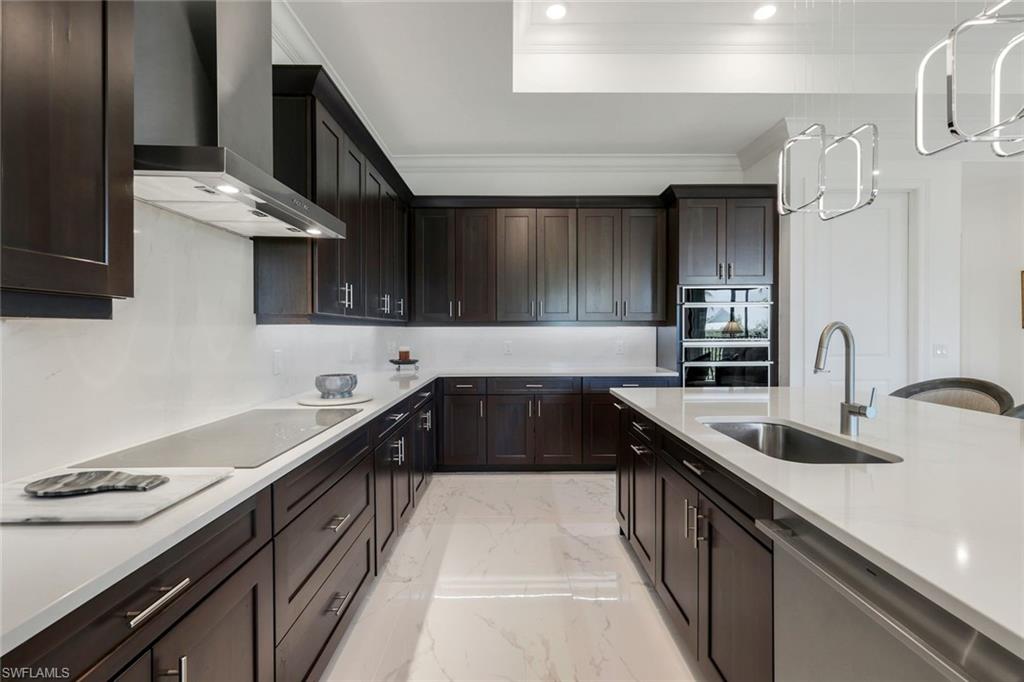 2488 Breakwater Way, Unit 201 Naples, FL 34112 - Photo 9 of 48 a kitchen with granite countertop a sink stove and cabinets