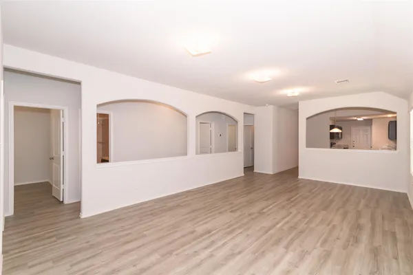 a view of a room with wooden floor