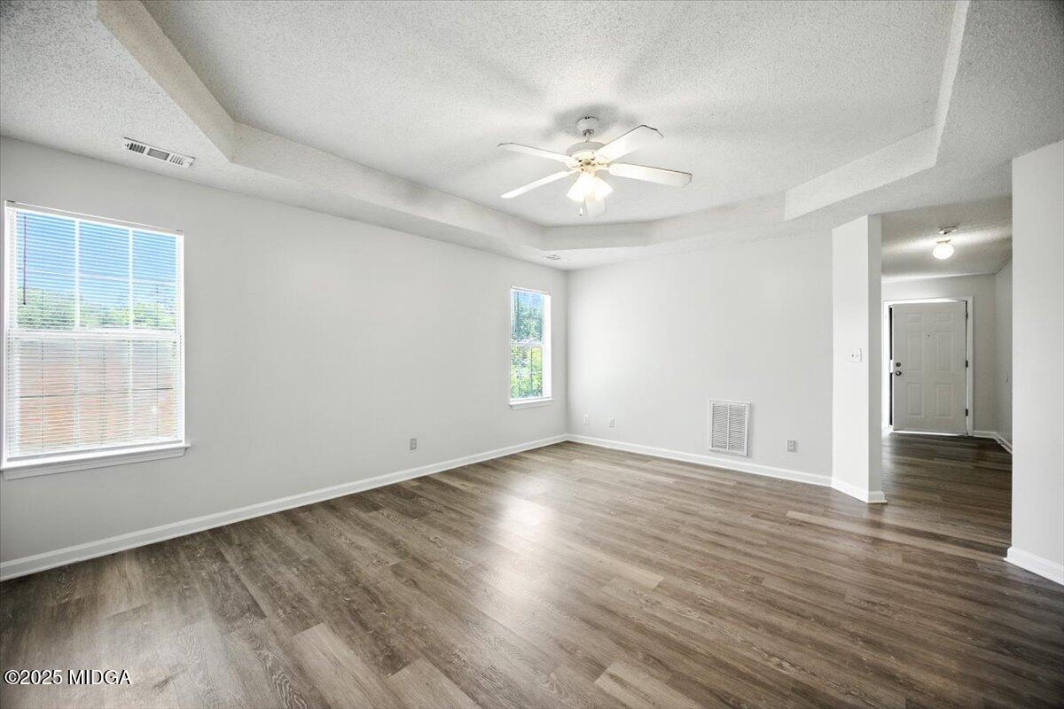 4801 Wilson Road Macon, GA 31206 - Photo 12 of 18 a view of an empty room with wooden floor and a window