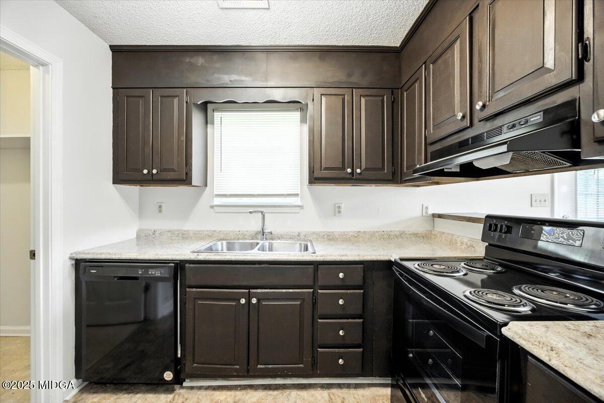4801 Wilson Road Macon, GA 31206 - Photo 14 of 18 a kitchen with a sink stove and cabinets