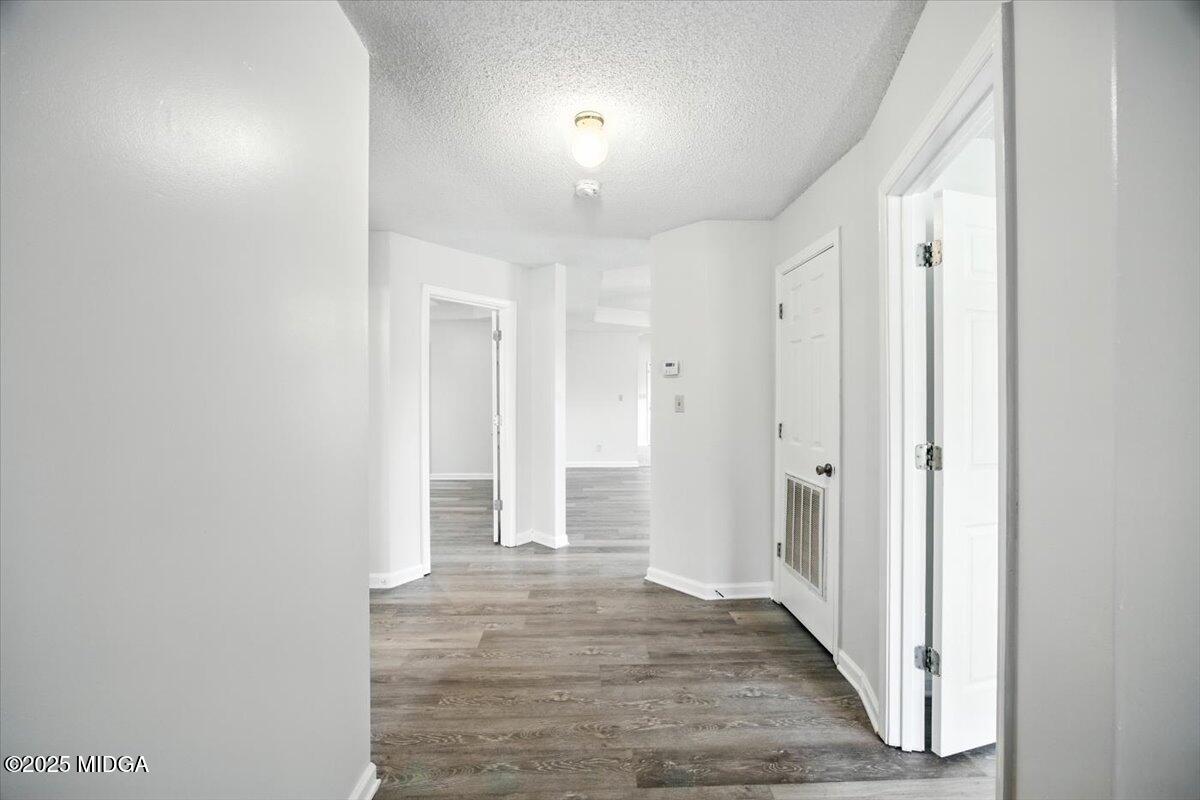 4801 Wilson Road Macon, GA 31206 - Photo 3 of 18 a view of a hallway with wooden floor and closet