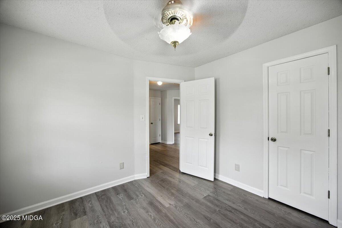 4801 Wilson Road Macon, GA 31206 - Photo 5 of 18 a view of an empty room with wooden floor