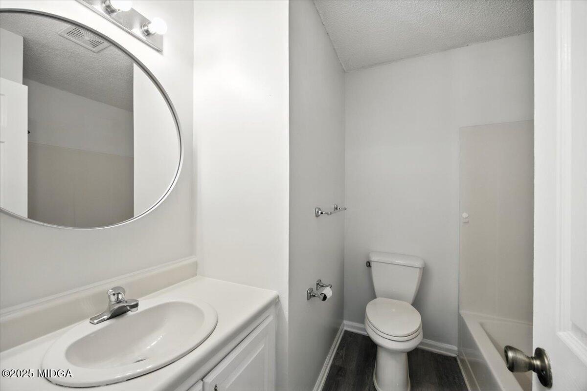 4801 Wilson Road Macon, GA 31206 - Photo 6 of 18 a bathroom with a sink toilet and a mirror