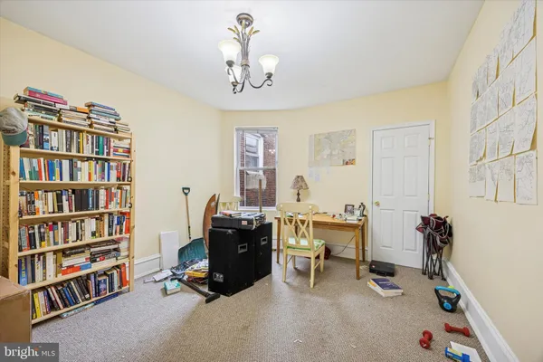a view of a livingroom with workspace and a window