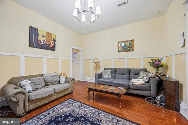 a living room with furniture a couch and dresser