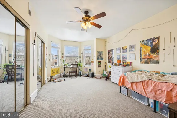 a bedroom with furniture and a large window