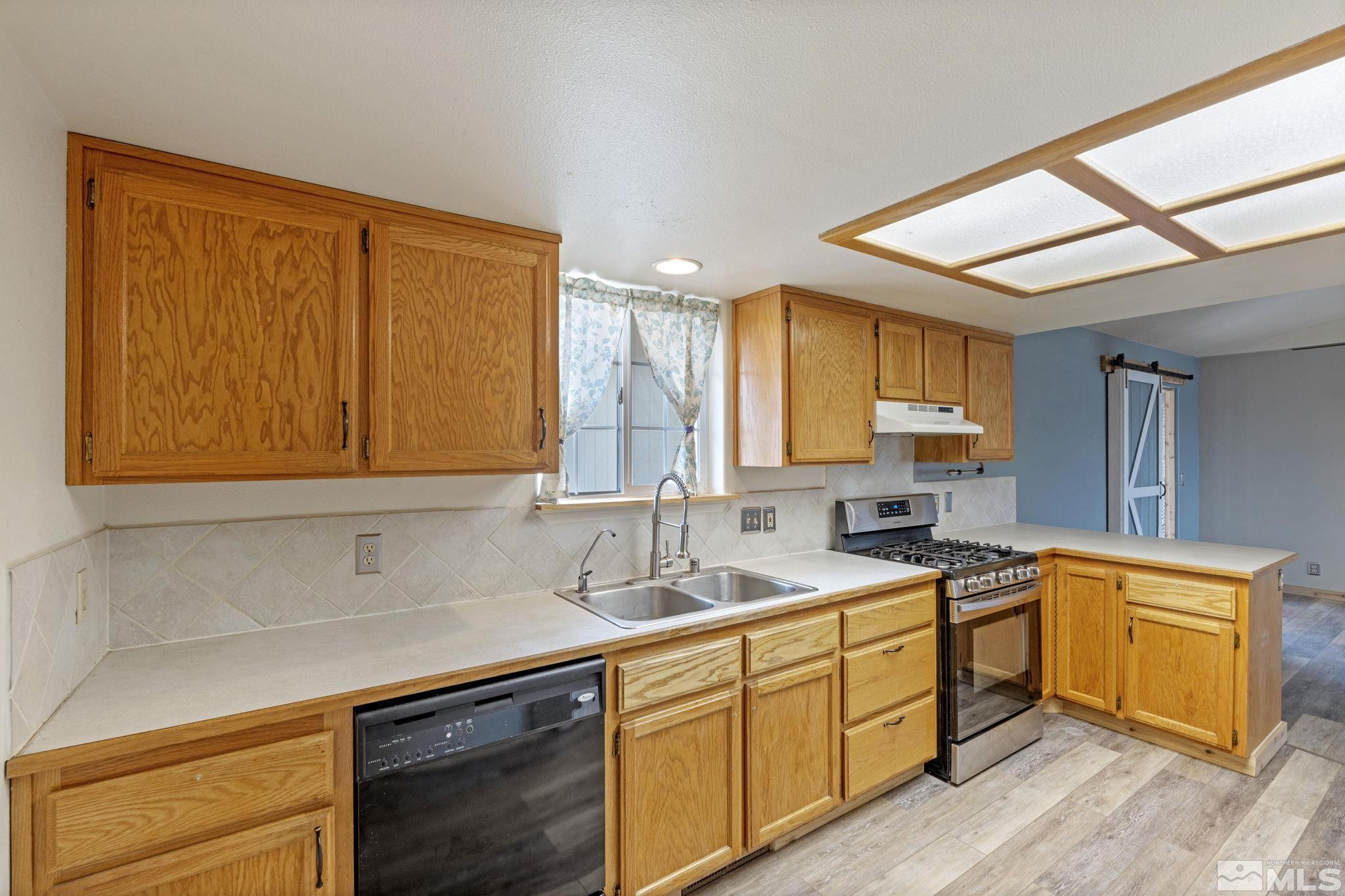 1240 Lattin Road Fallon, NV 89406 - Photo 12 of 34 a kitchen with a sink cabinets and window