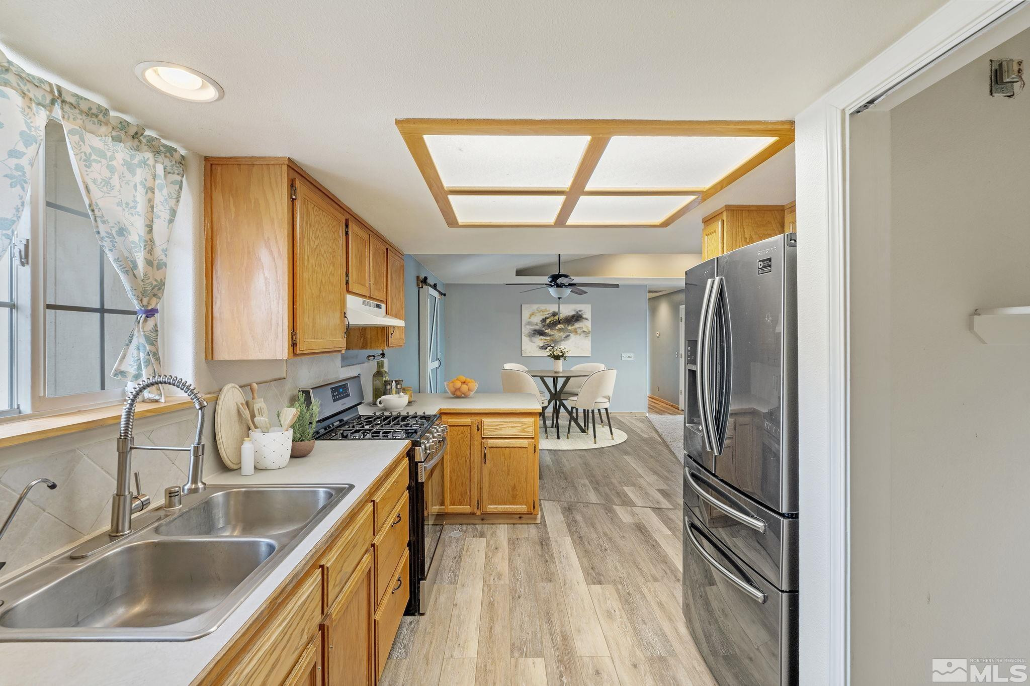 1240 Lattin Road Fallon, NV 89406 - Photo 13 of 34 a kitchen with stainless steel appliances granite countertop a sink refrigerator and cabinets