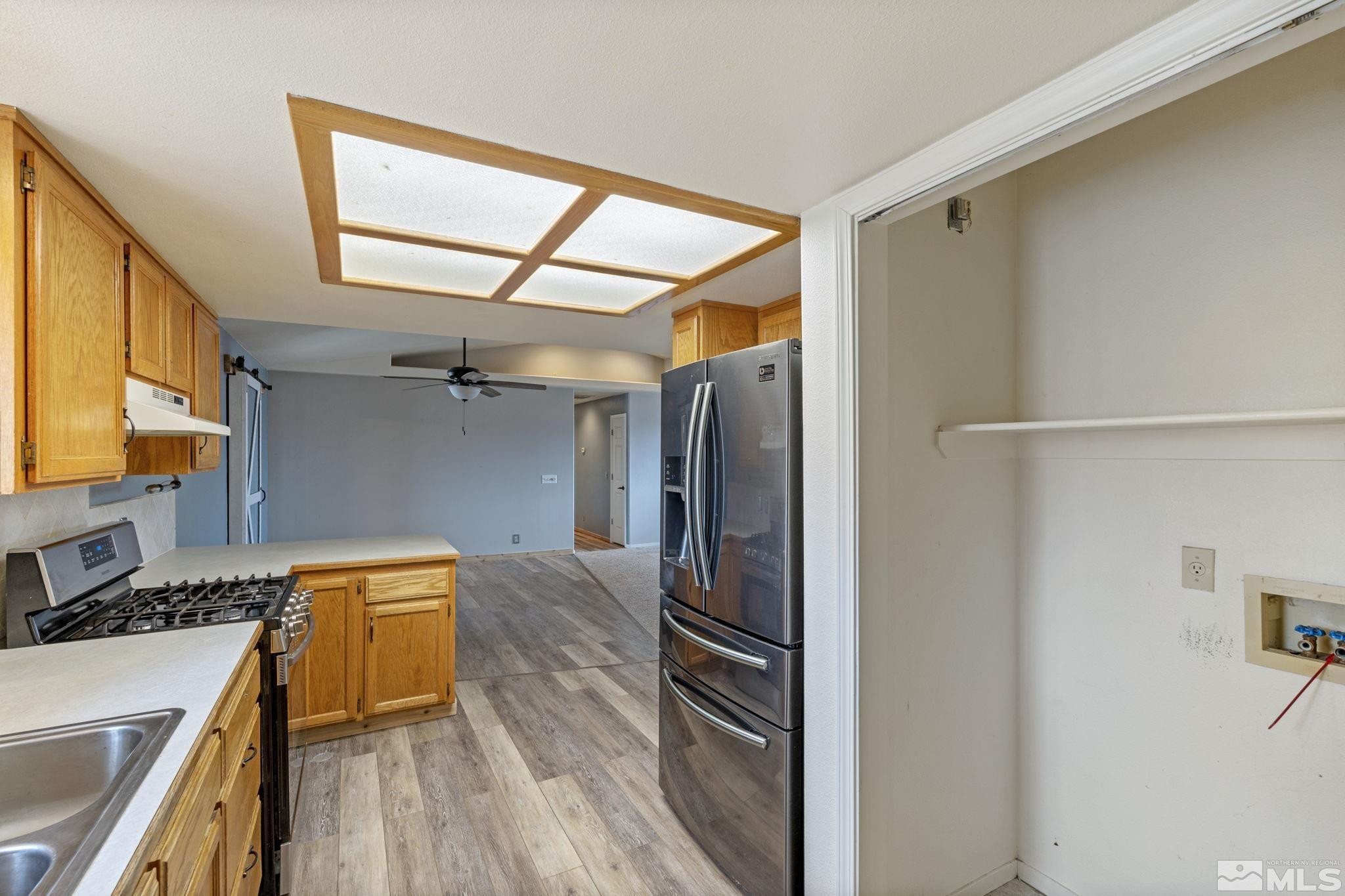 1240 Lattin Road Fallon, NV 89406 - Photo 17 of 34 a kitchen with a refrigerator and a sink