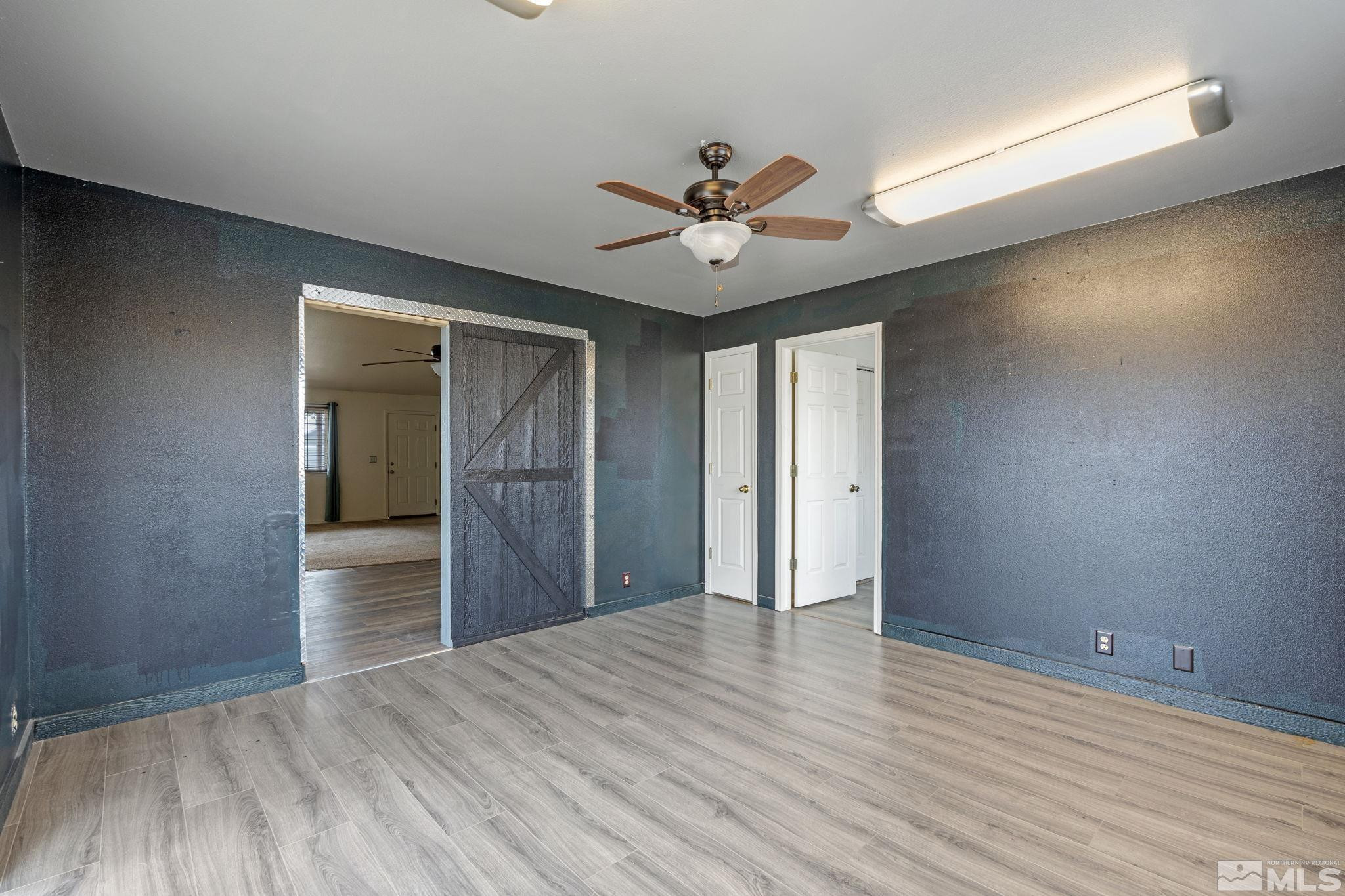 1240 Lattin Road Fallon, NV 89406 - Photo 20 of 34 a view of empty room with wooden floor and fan