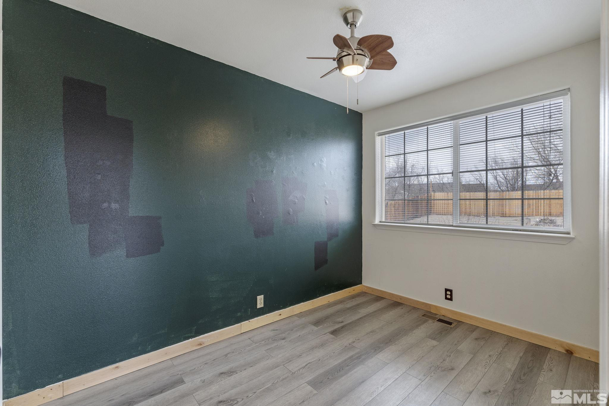 1240 Lattin Road Fallon, NV 89406 - Photo 22 of 34 a view of empty room with wooden floor and fan