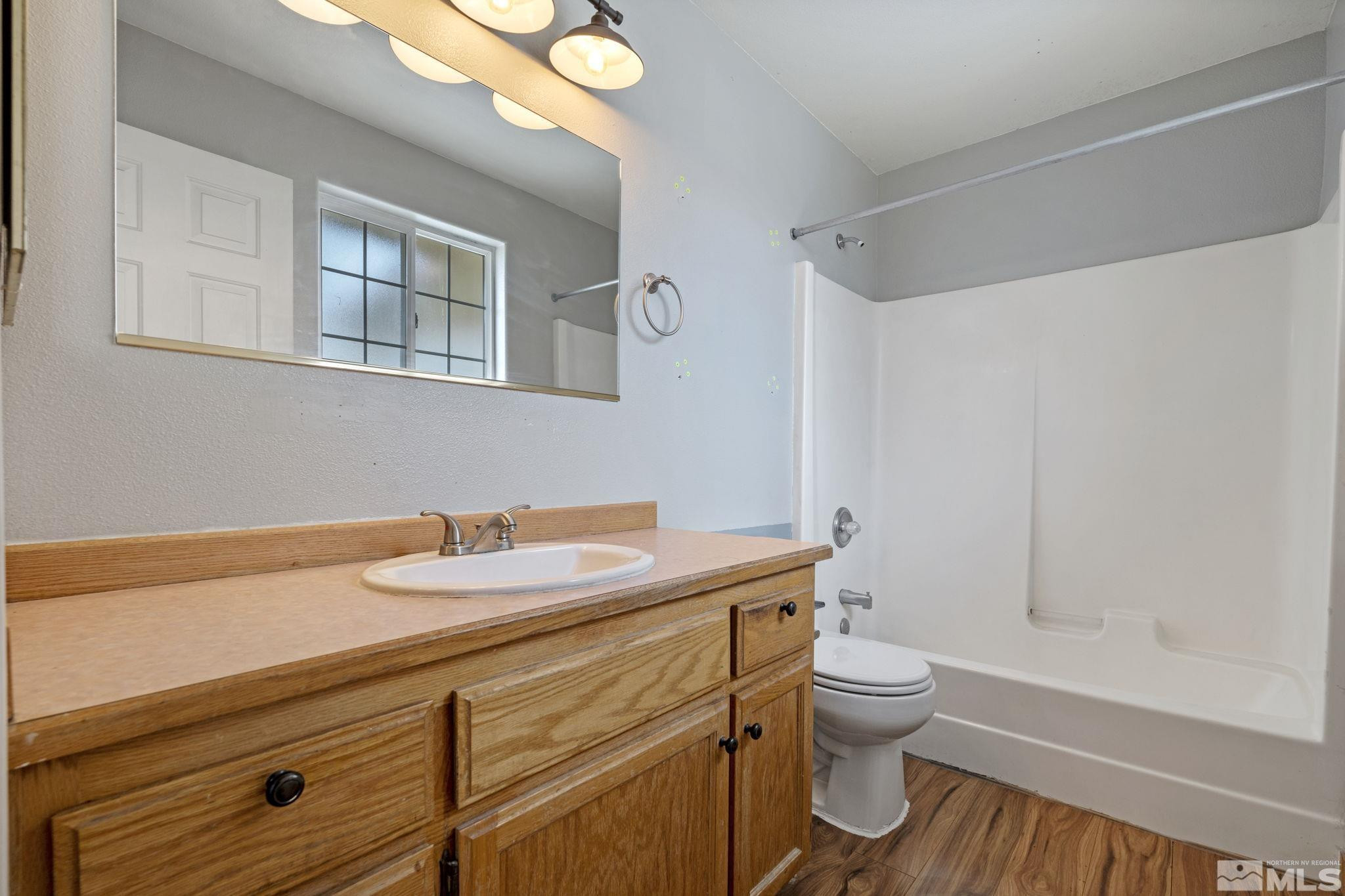 1240 Lattin Road Fallon, NV 89406 - Photo 27 of 34 a bathroom with a granite countertop toilet sink and mirror