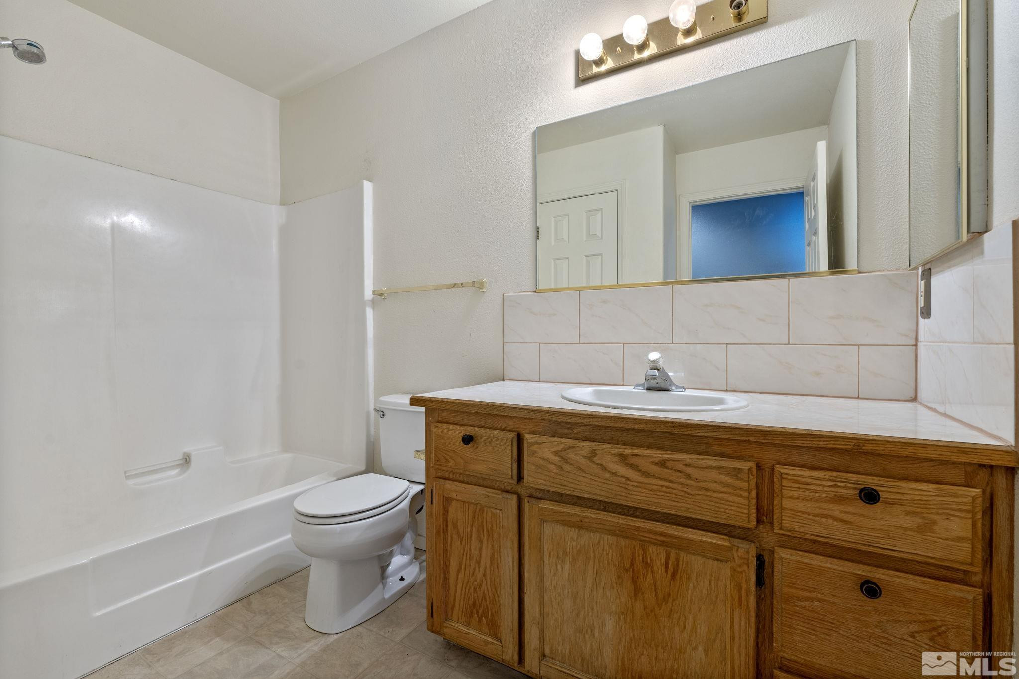1240 Lattin Road Fallon, NV 89406 - Photo 30 of 34 a bathroom with a toilet sink and mirror