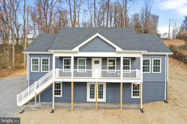 a front view of a house with a garage and balcony
