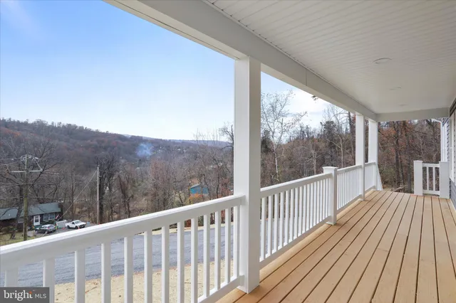 a view of balcony with wooden floor and fence
