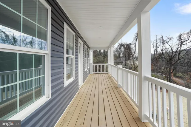 a view of balcony with wooden floor and fence