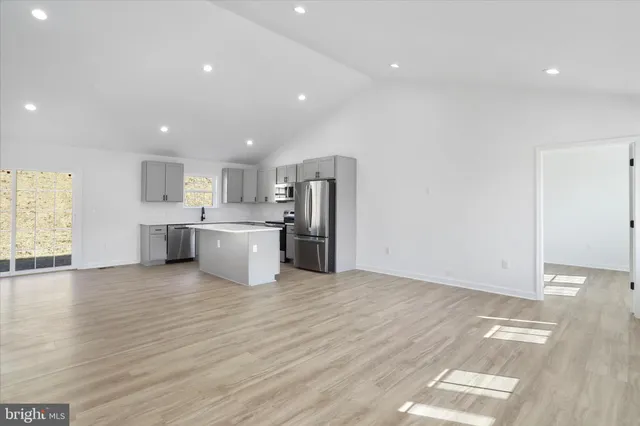 a view of a kitchen with a sink and a refrigerator