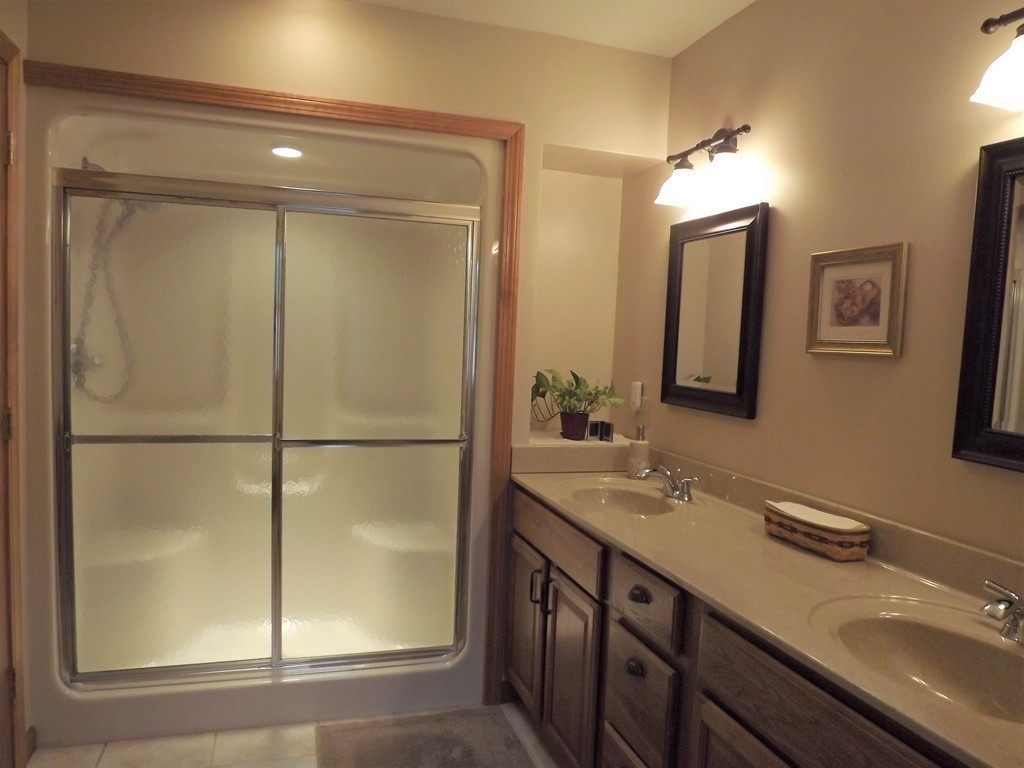 78 Bogan Road Monson, MA 01057 - Photo 12 of 20 a bathroom with a double vanity sink and mirror